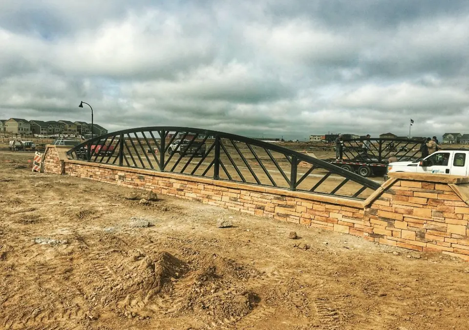 Steel railing mounted on a stone retaining wall